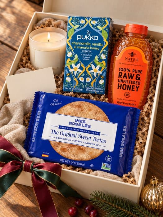 Candlelit Tea & Honey gift box — soy wax candle in a frosted white glass jar with a natural wood lid, Pukka Organic Chamomile, Vanilla & Manuka Honey Herbal Tea, Nate's Honey 100% Pure Raw & Unfiltered Honey, Ines Rosales The Original Sweet Tortas