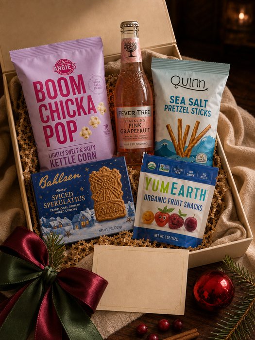 Holiday Movie Night gift box — lightly sweet popcorn, sea salt pretzels, fruit snacks, spiced speculaas cookies and a bottle of sparkling pink grapefruit soda