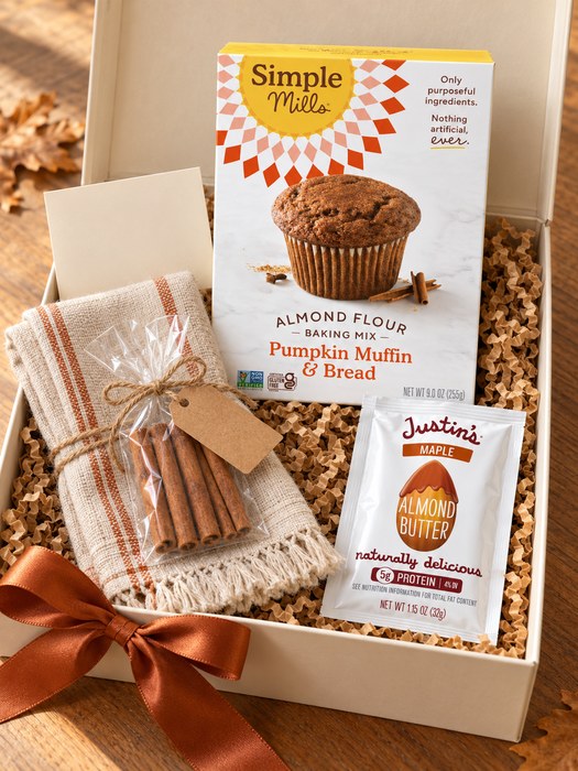 Harvest Bake Box gift box — tasseled cotton tea towel, Simple Mills Almond Flour Pumpkin Muffin & Bread Mix, cinnamon sticks, Justin's Maple Almond Butter Squeeze Pack